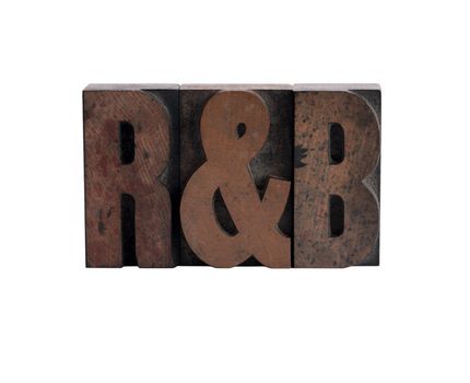 abbreviation of the term 'rhythm and blues' in ink-stained letterpress wood type
