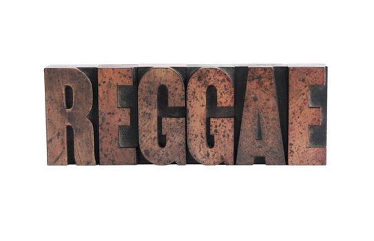 the word 'reggae' in ink-stained wood letters isolated on white