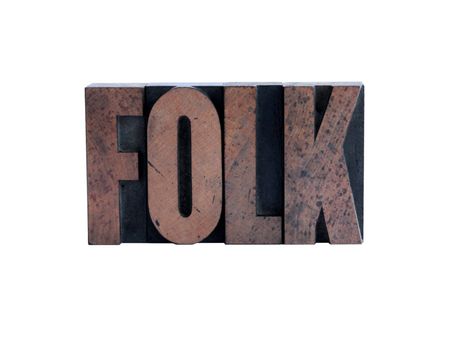 the word 'folk' in ink-stained wood letters isolated on white