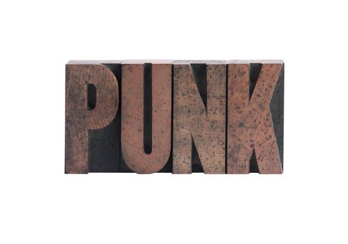 the word 'punk' in ink-stained wood letters isolated on white