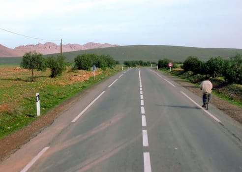 a road is going through a nice landscape in the countryside of Morocco
