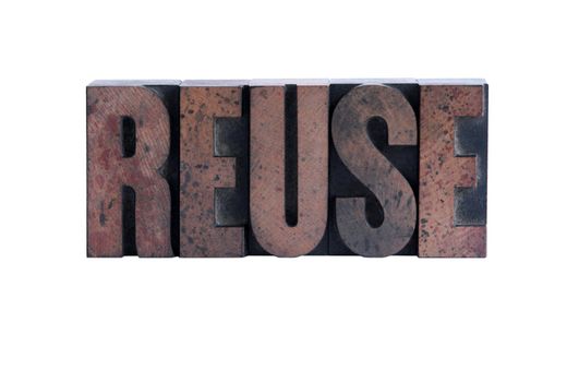 the word 'reuse' in ink-stained wood letters isolated on white