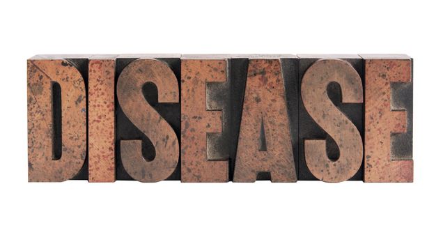 the word 'disease' in ink-stained wood letters isolated on white