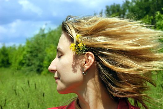 girl with flying hair and closed eyes enjoying wind