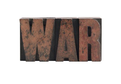 the word 'war' in ink-stained wood letters isolated on white