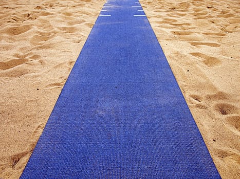 Longjump sand pits devided by a blue track. 