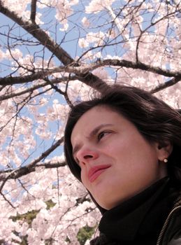  Portrait of a woman with cherry blossom twigs in background         