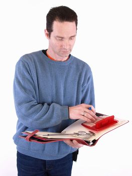 An adult male in blue checks over some measurements in a binder. Isolated on a white background.