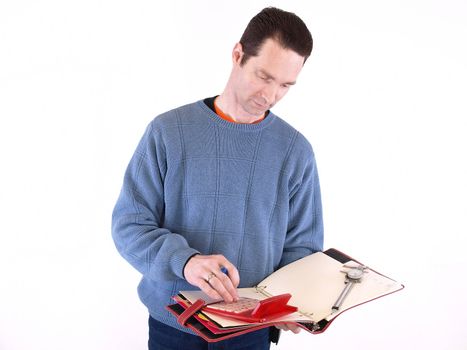An adult male in blue checks over some measurements in a binder. Isolated on a white background.