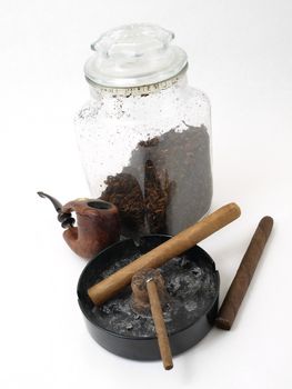 Smoking paraphernalia including cigars, pipe and loose leaf tobacco in a glass container, isolated on a white background