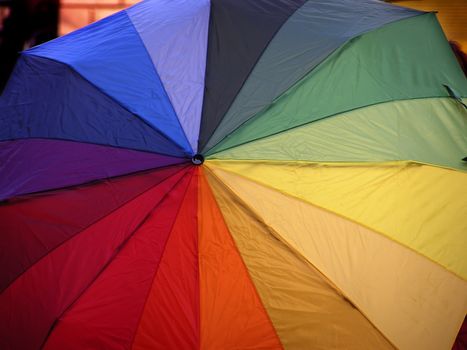 Opened funny umbrella with all rainbow colours.