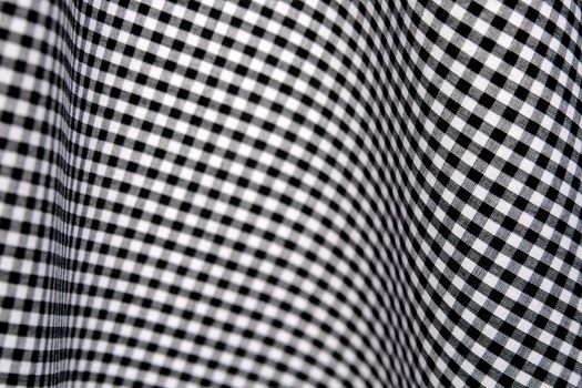 black and white checks in a gingham fabric, draped to give a curvy, op art effect