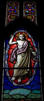 detail of victorian stained glass church window in Fringford depicting Jesus ascending to heaven