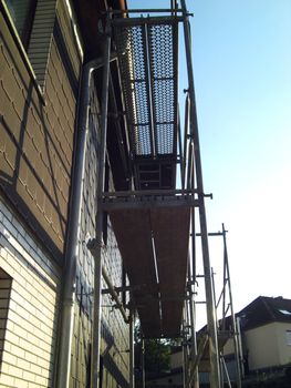 steel and wood scaffold at a construction site of a building in renovation 