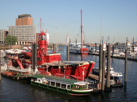 Old red lightship in Hamburg harbour, Germany. Also many other boats and ferries.