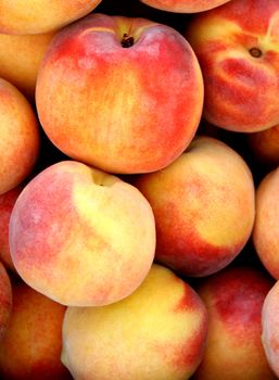Close up of a bushel of fresh peaches

