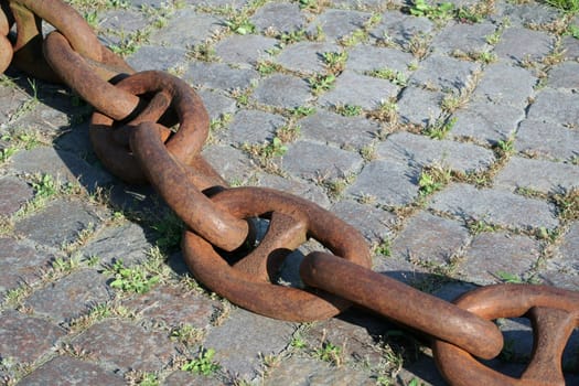 A very heavy rusty anchor chain in the harbour of Hamburg. Not in use anymore.