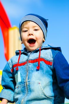 happy screaming three year old boy playing outdoor