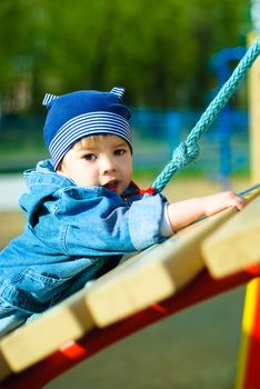 cute three year old boy playing outdoor at the Children's playground