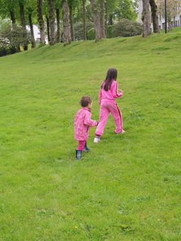 kis walking uphill in the grass