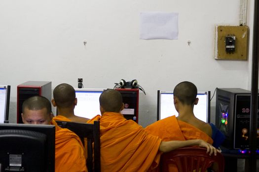 Young Monks in Luang Prabang spend their free time on the Internet. Illustrates how the new and old are getting more combined.