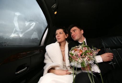 The bride and groom in automobile