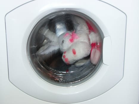 The image of the toys turning in a washing machine