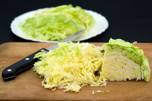 cut heads of cabbage on a black background