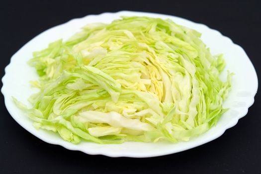 cut fresh cabbage on a white plate