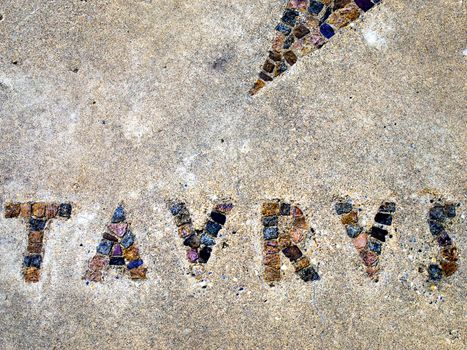 Inlaid tile spelling out the astrological sign of Taurus.