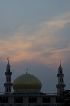 A mosque in Phnom Penh set against a beautiful sunset sky. 