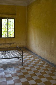 The former school that was turned into the dreaded prison and torture chamber Toul Sleng during the reign of Pol Pot. This photo shows one of the torture chambers / former classrooms. Victims were locked to the bed and tortured until death. 