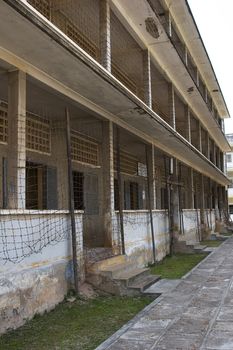 The former school that was turned into the dreaded prison and torture chamber Toul Sleng during the reign of Pol Pot. Now a museum, this photo is of one of the prison cells, with barbed wire in front to keep the prisoners from killing themselves. 