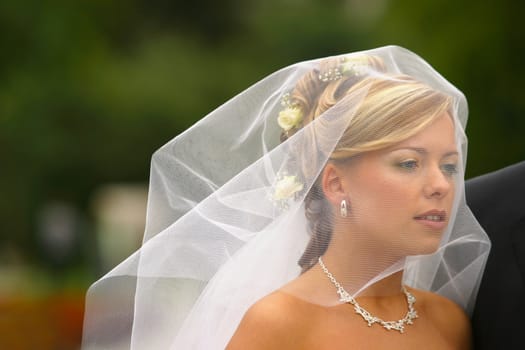 The beautiful bride in movement under a veil