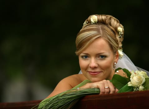 Portrait of the beautiful bride with a bouquet