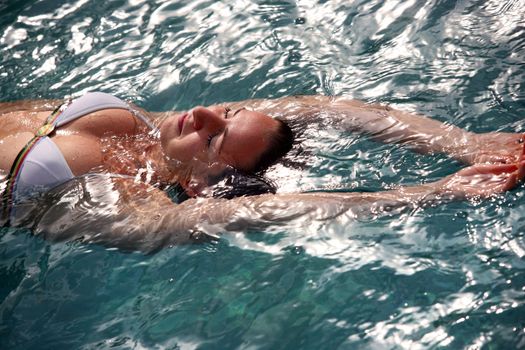 Beautiful woman enjoying summer in the pool