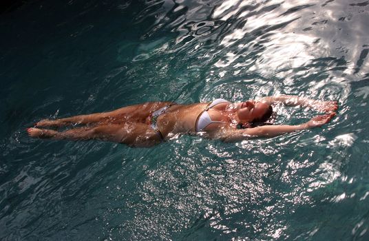 Beautiful woman enjoying summer in the pool