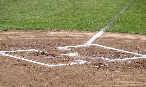 A closeup view of home plate on a baseball field