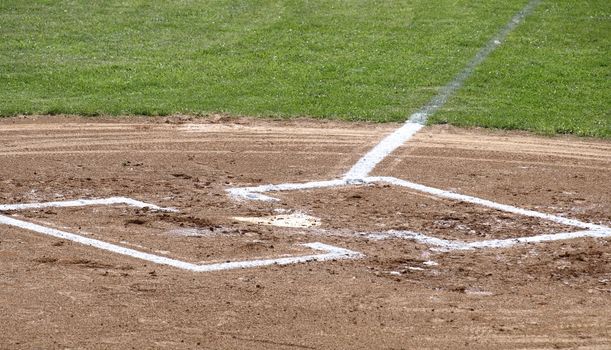 A closeup view of home plate on a baseball field