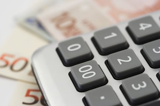 Euro bills and calculator close up