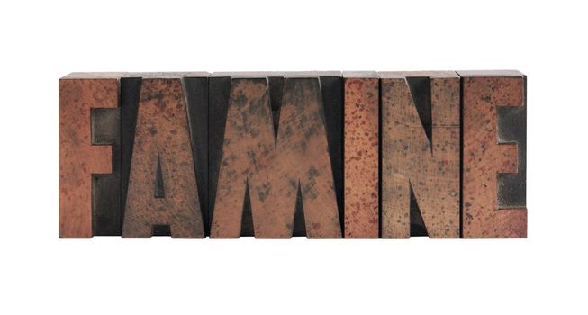 the word 'famine' in old, ink-stained wood type