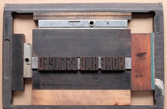 a printer's chase holds wood type ready for the press