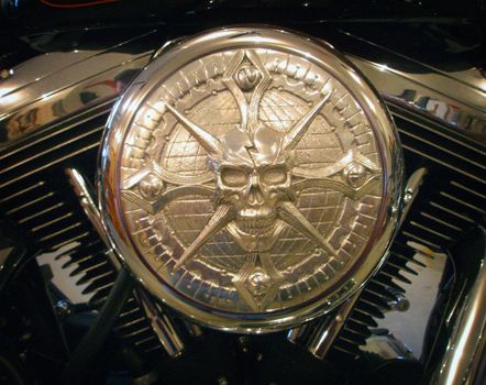 Close up image of an air filter cover on a Harley Davidson motorcycle with Skull.