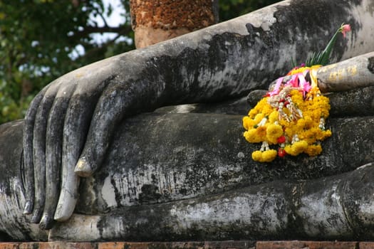 Detail of one of the many buddha statues at Sukhotai historical park in Thailand