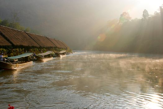 Junglerafts in morning mist on the river kwai near Kanchanaburi, Thailand