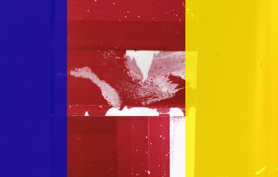 background of red, blue and yellow printer blotting papers with streaks and spots