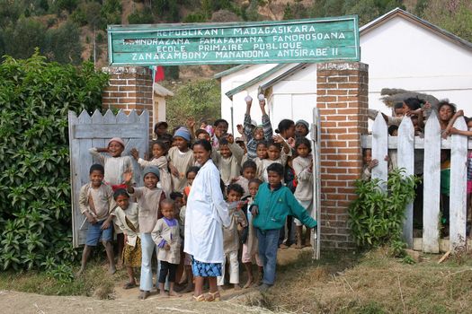 The entire school is running out of the gates to have a look at those strange white tourists that stop by the side of the road