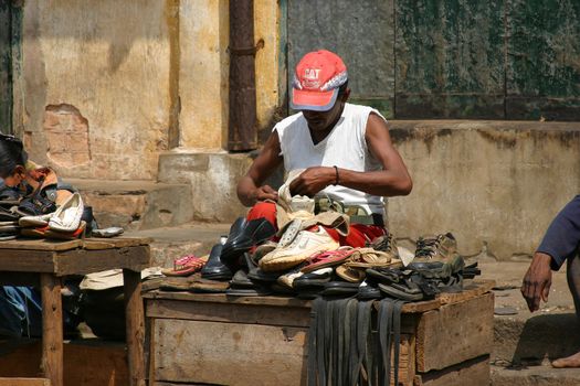 Old shoes get a new life due to this street shoe repair man in Madagascar