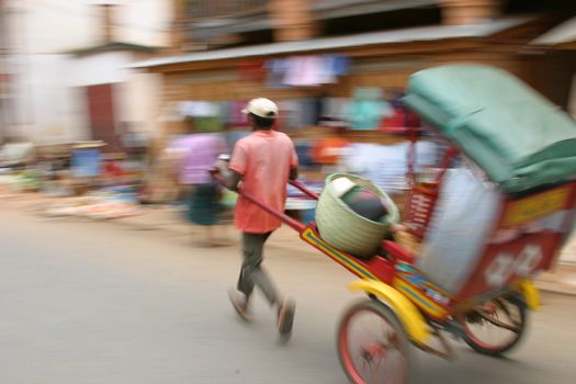 Pousse pousse driver in the streets of Ambositra, Madagascar