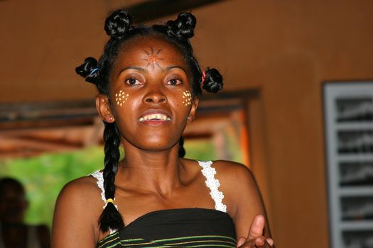 Woman in Madagascar having painted her face to celebrate